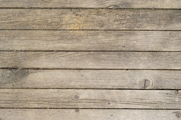Obraz premium Wooden background from old boards. Joints are filled with earth.
