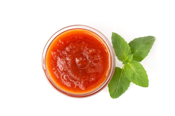 Bowl of tomato sauce with green mint leaf, isolated on white background.