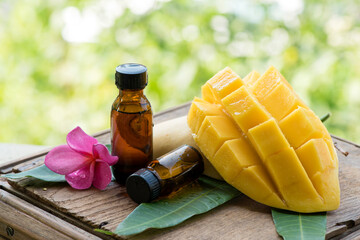 Mango fruit and extracted in the bottle on nature background.