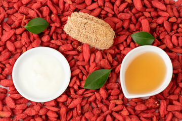 Face mask with goji berry ,yogurt and honey for skin treatment on boji berry background.top view,flat lay.