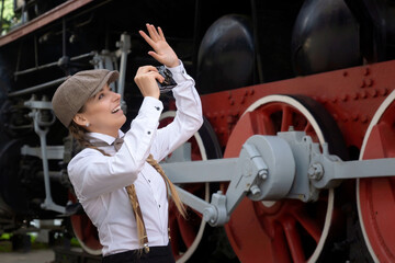 Young beautiful girl dressed in mens clothing of the twenties. The style of the great Gtsby.