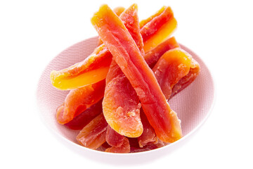 Dry papaya sticks in a light plate on a white background.isolated products