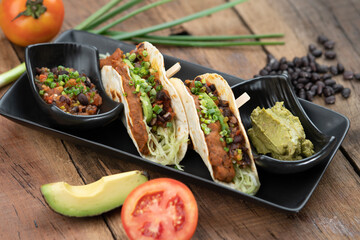 Baked tortillas with black beans, tomato, cilantro, red onion, avocado and assorted spices served...