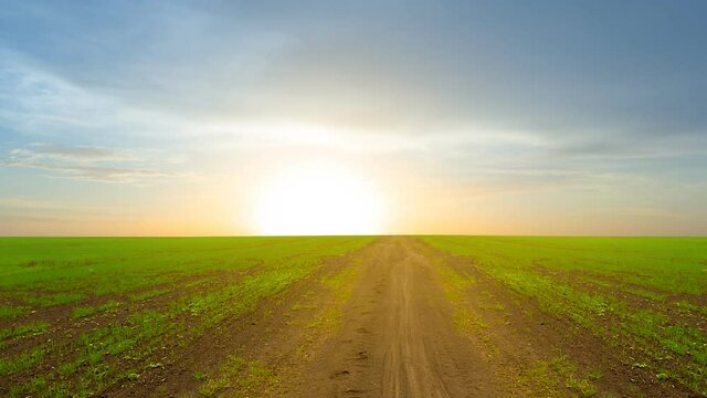 ground road through green rural field, countryside time lapse scene