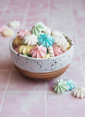 Small colorful meringues in the  ceramic bowl