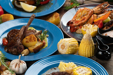 Set of smoked grilled bbq meals; meat; fish and vegetables isolated on rustic wooden table