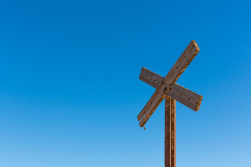Old railway crossing sign against a clear blue sky in the township of Silvertown in western New South wales, Australia