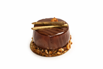 Chocolate and caramel cake isolated on a white background.