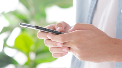 Close up of man hand holding mobile phone , People on smart phone, technology lifestyle