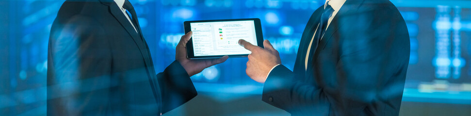 The businessmen with a tablet on the virtual screen background