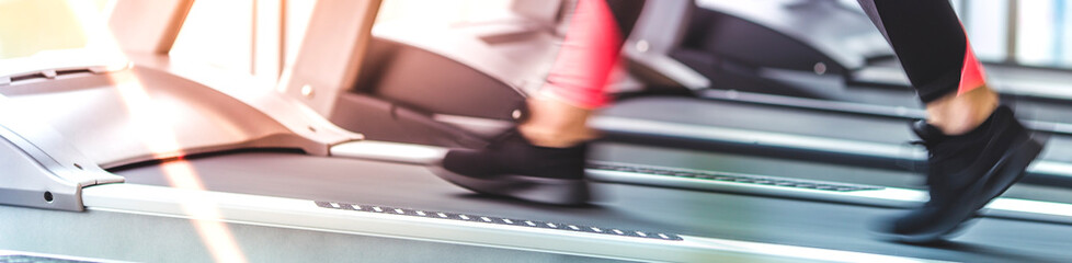 The woman legs running on the treadmill in the gym