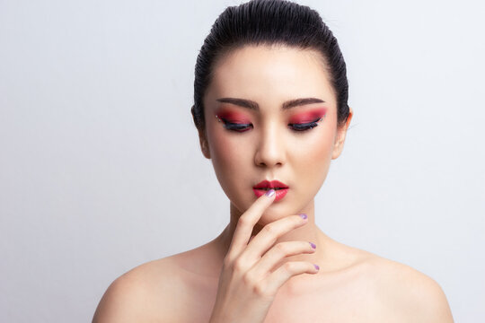 Makeup Asian woman close eyes show colorful eyeshadow with extreme long false eyelashes. Eyelash Extensions. Makeup, Cosmetics, Beautiful cosmetics makeup concept.