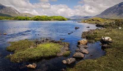 Fototapeta premium Beautiful landscape scenery of lough inagh with mountains and trees in the background at Connemara National park in county Galway, Ireland 