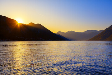 South Island is stunning coastal region . Sunset over the mountains and sea . Lagoon Surrounded by Mountains