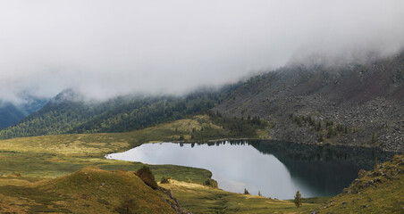 Wild mountain lake, natural light in cloudy