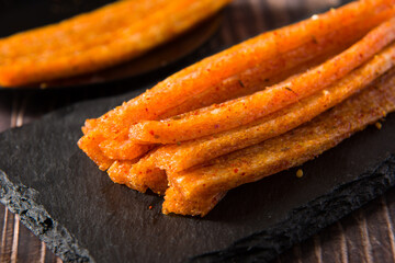 Chinese street snacks.Article spicy,Spicy gluten latiao on wood background