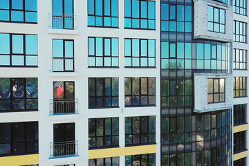 Many windows on new apartment building facade under construction. Real estate development.