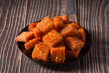 Chinese street snacks.Article spicy,Spicy gluten latiao on wood background