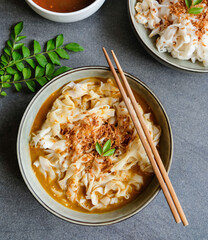 Typical Malaysian street food / Curry Chee Cheong Fun aka Rice Noodle Roll / Choice of soy and chili paste or curry gravy sauce, garnished with sesame seeds and ground deep fried crispy dried shrimp