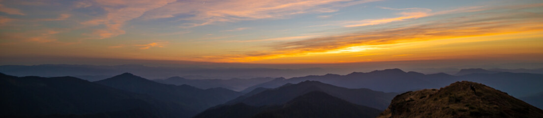 Fototapeta na wymiar The picturesque sunset above mountains