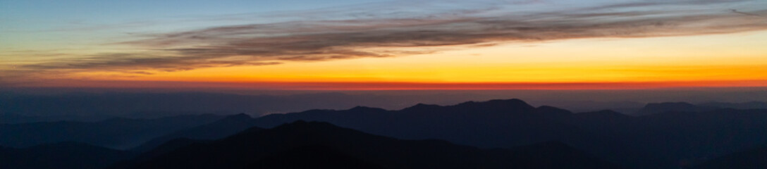The picturesque sunrise above mountains. evening night time