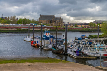 Fototapeta premium A view down a slipway on the River Kelvin where it joins the River Clyde in Glasgow on a summers day