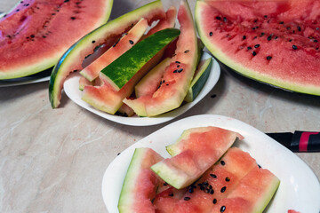Watermelon and watermelon peels on plates on the table, home photo