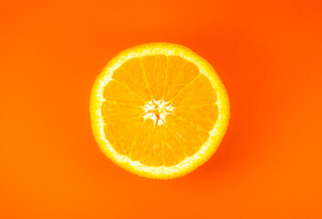 Close up photo of orange texture on the orange background. Fruit cut in half, inside, macro view....