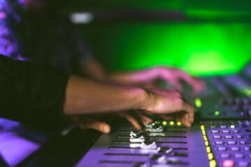 Audio engineer working with mixer panel control in music recording studio