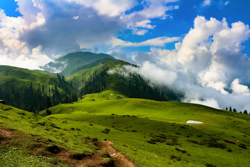 Payee meadows Shogran North Pakistan is lush green meadow mostly show and cloud covered 