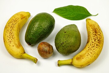Ripe avocado and speckled bananas lie on a white table