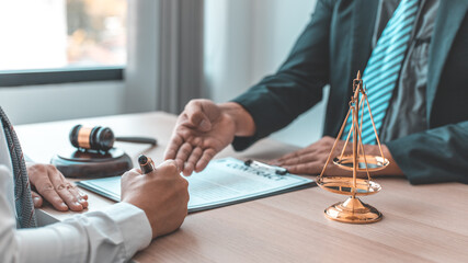 Lawyer or judge has recommend a client sign a legal agreement in the courtroom, Legal Agreement Documents and Business Litigation Forms, scales of justice, law hammer, Litigation and legal services.