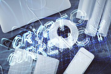 Blockchain theme hologram drawings over computer on the desktop background. Top view. Multi exposure. Concept of cryptoeconomy.