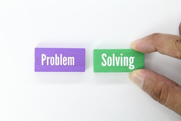 purple and green wooden blocks with the word problem solving