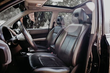 Black leather car seats outdoor.