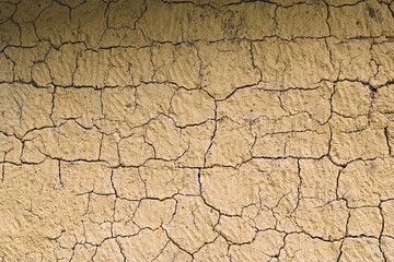 Mud wall texture background. Cracks in a mud wall. Yellow wall. Wall made with bahareque - obrazy, fototapety, plakaty