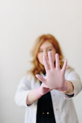 A female doctor in a white coat with a stethoscope