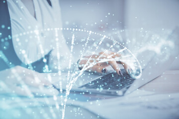 Double exposure of woman hands typing on computer and DNA hologram drawing. Medical education concept.