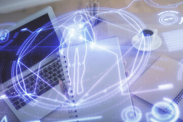 Double exposure of woman hands typing on computer and general theme hologram drawing. Education concept.