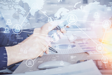 Double exposure of man's hands holding and using a phone and social network theme drawing.