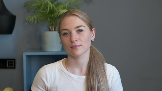 Happy millennial casual professional lady with white teeth pretty face posing for close up portrait indoors.