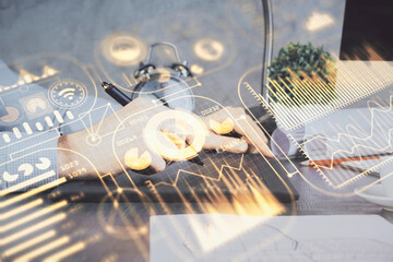 Double exposure of man's hands holding and using a digital device and tech theme hologram drawing. Technology concept.