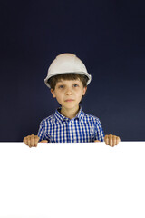 Happy little boy in the helmet against white banner.
