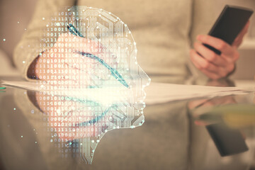Double exposure of brain sketch hologram and woman holding and using a mobile device.