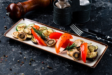 Set different grilled vegetables on a plate. Vegan barbeque picnic set, with mushrooms, peppers