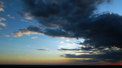 Beautiful contrasting clouds in the sky at sunset. Background for design