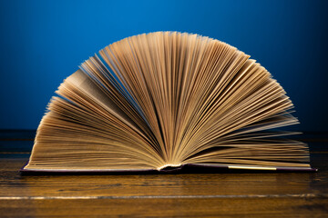 open book on a table on a gradient background with page turning