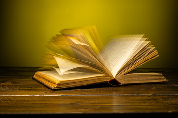 open book on a table on a gradient background with page turning