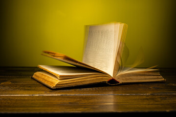 open book on a table on a gradient background with page turning