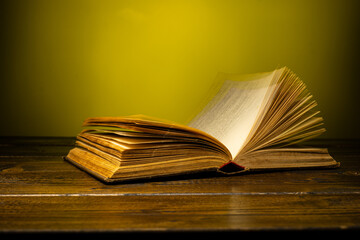 open book on a table on a gradient background with page turning